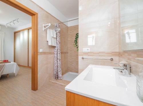 a bathroom with a sink and a shower at Villa Sa Planeta in Sant Josep de Sa Talaia