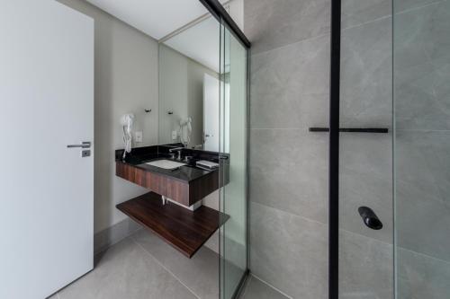 a bathroom with a sink and a shower at Charlie On The Parc Ibirapuera Hotel in Sao Paulo