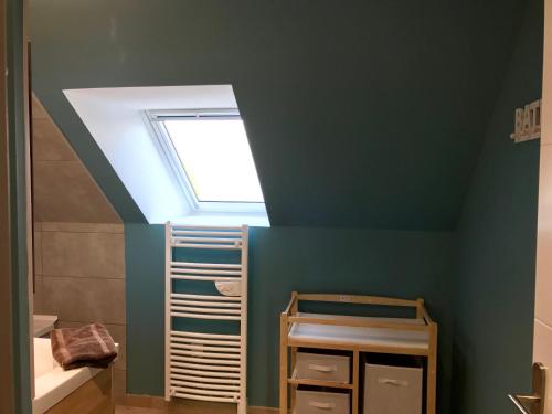 a bathroom with a ceiling with a skylight at Petale de Rose, Dunes 3 in Merlimont