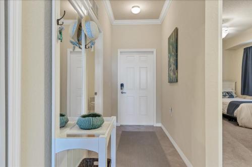a hallway with a room with a bed and a table at Caddy's Corner! Golf Course Views! Located in River Strand Golf & Country Club in Bradenton