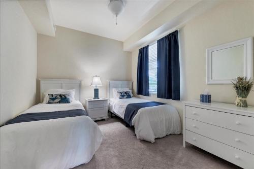 a bedroom with two beds and a window at Caddy's Corner! Golf Course Views! Located in River Strand Golf & Country Club in Bradenton