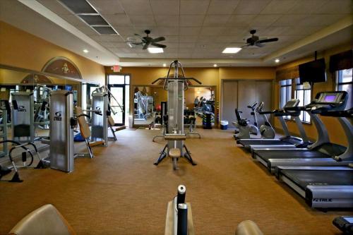 a gym with treadmills and machines in a room at Caddy's Corner! Golf Course Views! Located in River Strand Golf & Country Club in Bradenton