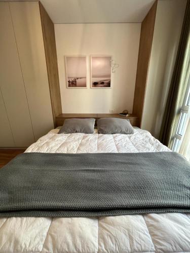 a large bed in a room with a window at Boo_Apartment in Draç