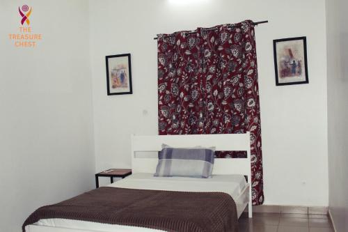 a bedroom with a bed and a red curtain at Two Bedroom Villa at Ouagadougou in Ouagadougou