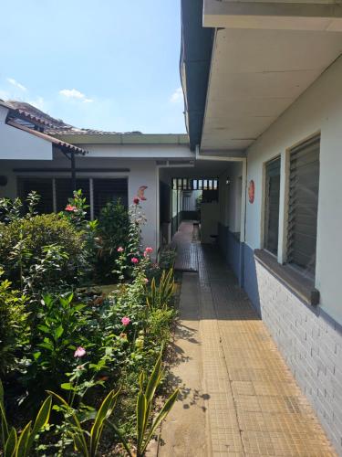 a hallway of a building with flowers and plants at Casa 25 hostal in Santa Ana