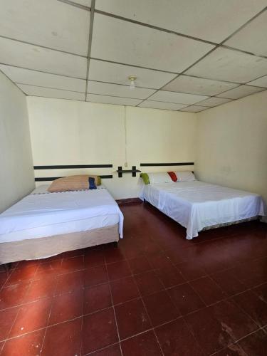 a room with two beds in a room at Casa 25 hostal in Santa Ana