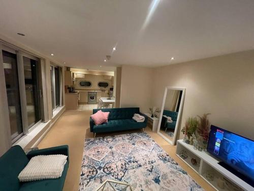 a living room with a couch and a flat screen tv at Free parking and wi-fi near city centre sleeps 6-8 in Leicester