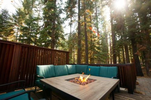 a blue couch sitting on a deck with a fire pit at The Tallac Lodge Hot Tub Walk 2 Beach in Carnelian Bay