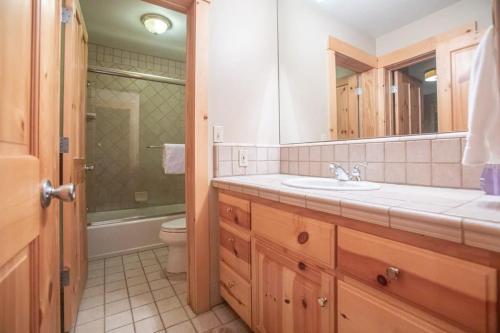 a bathroom with a sink and a toilet at The Tallac Lodge Hot Tub Walk 2 Beach in Carnelian Bay