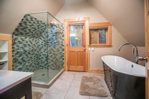 a bathroom with a shower and a bath tub at The Tallac Lodge Hot Tub Walk 2 Beach in Carnelian Bay