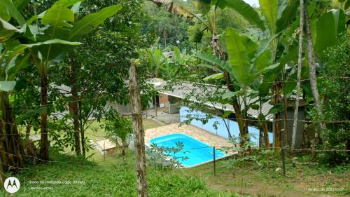 a pool in the middle of a garden at ESPAÇO ShEHERAZADE PISCINA & LAZER in Juquitiba