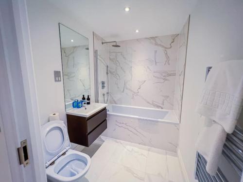 y baño blanco con aseo y ducha. en 30% Off Monthly Stay/2Bed House - Sittingbourne en Kent