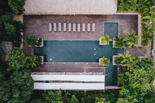 an overhead view of a building with a swimming pool at Naio Hotel y Villas in Palomino