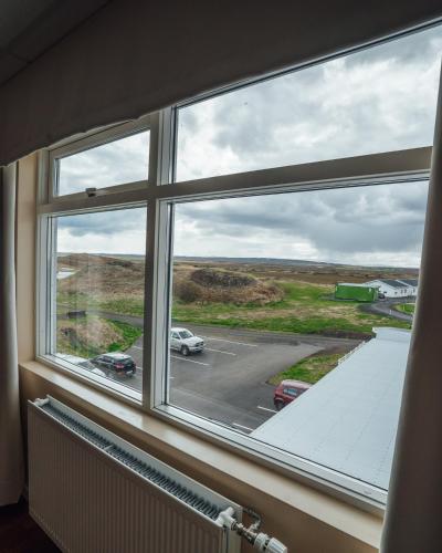 a window with a view of a parking lot at Sel - Hótel Mývatn in Myvatn