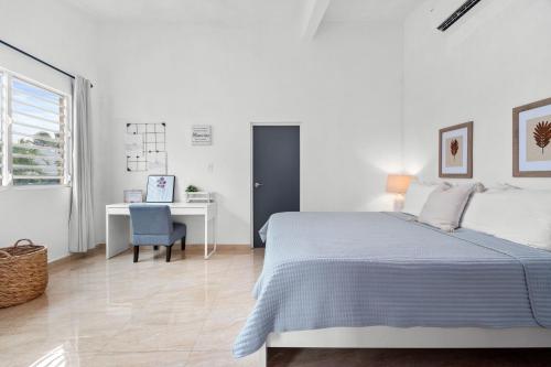 Habitación blanca con cama y escritorio en 4 bedroom family reserve with pool home, en Dorado