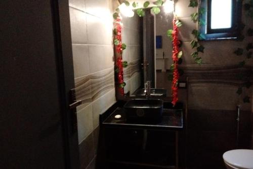 a bathroom with a sink and a mirror at Two pools private villa for families. in Qaryat Shākūsh