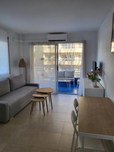 a living room with a couch and a table at Beautiful apartment with swimming-pool in Salou