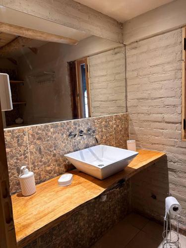 a bathroom with a large white sink on a counter at Casa Playa Mansa in Mina Clavero
