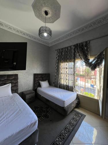 a bedroom with two twin beds and a window at A room in Guéliz only for ladies in Marrakesh