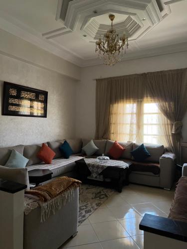a living room with a couch and a chandelier at A room in Guéliz only for ladies in Marrakesh