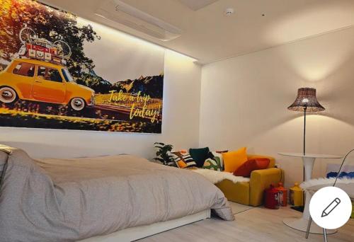 a bedroom with a painting of a car on the wall at Best memory 신축 지하철도보5분 인천공항버스1시간 김포공항지하철20분 용산KTX역40분 in Bucheon