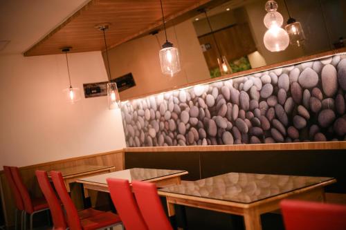 a restaurant with two tables and red chairs at KIWI-Taichung Station Branch 1 in Taichung