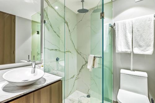 a bathroom with a sink and a glass shower at Ocean Vista Oasis at Maritima Playa in Bucerías