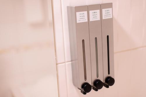 a set of kitchen utensils hanging on a door at KIWI-Taichung Station Branch 1 in Taichung