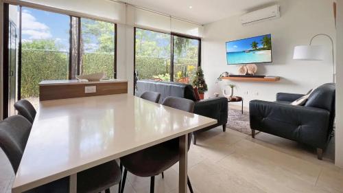 a living room with a table and chairs at Exclusive fully equipped Condo with great pool in Jacó