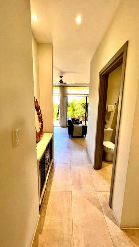 a hallway of a house with a living room at Exclusive fully equipped Condo with great pool in Jacó