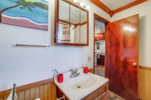 a bathroom with a sink and a mirror at Dog-Friendly Michigan City Home - 3 Mi to Beach! in Michigan City