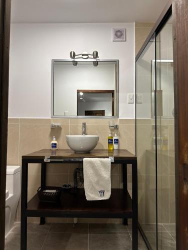 a bathroom with a sink and a mirror at El Museo Hotel Boutique in La Paz