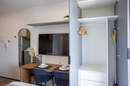 a small dining room with a table and blue chairs at 360 My Moema in São Paulo