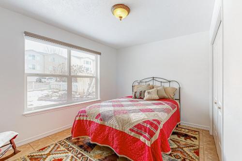 a bedroom with a bed and a window at The Swisher House in Pocatello