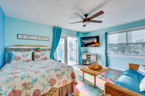 a bedroom with a bed and a ceiling fan at PCB Apt with Balcony and Gulf Views Walk to Beach in Panama City Beach