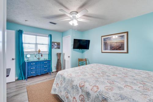 a bedroom with a bed and a ceiling fan at PCB Apt with Balcony and Gulf Views Walk to Beach in Panama City Beach