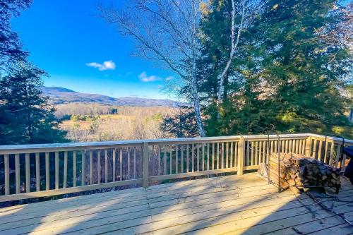 a wooden deck with a view of the mountains at Heart Of The Mountains in Thornton