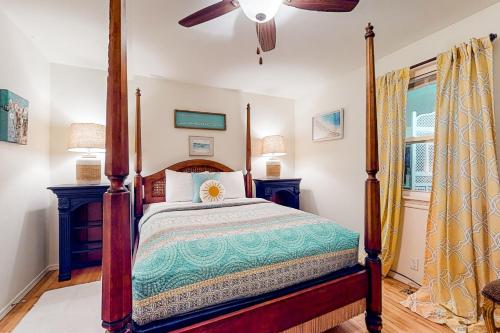 a bedroom with a canopy bed and a window at Monte Ne Getaway in Rogers