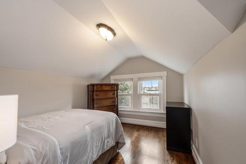 a white bedroom with a bed and a window at Plymouth Paradise in Plymouth