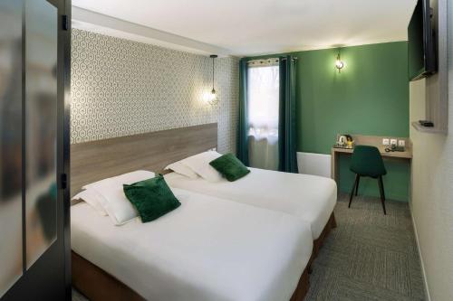 a hotel room with two beds and a desk at Sure Hotel by Bestwestern Rouvignies Valenciennes in Valenciennes