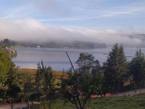 a view of a lake with clouds in the sky at Finca Refugio Guanumen in Tota