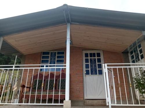awning over a porch of a brick house at Finca Refugio Guanumen in Tota