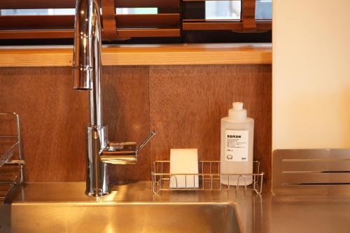 a kitchen sink with a bottle of soap on it at RIKKA BABA ICHI in Takayama