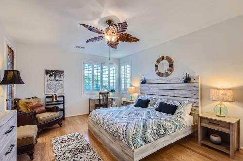 a bedroom with a bed and a ceiling fan at Phoenix Retreat with Heated Pool, Gas Grill and Yard! in Avondale