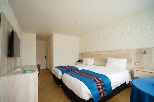 Кровать или кровати в номере Panamericana Hotel Arica