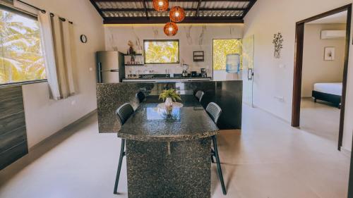 a kitchen with a island in the middle of a room at Mar e Lar in Maragogi