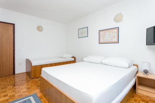 a room with two beds and a tv at Studio Podaca 6736b in Podaca