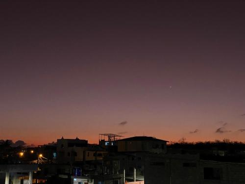 a view of a city at night at Departamento Raya in Puerto Ayora