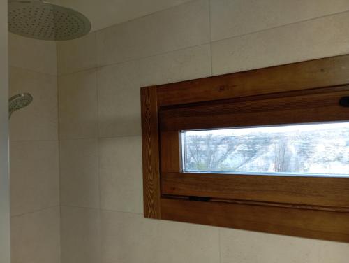 a bathroom with a window in a shower at Casa Rural Alikakaro in Alcalá del Júcar