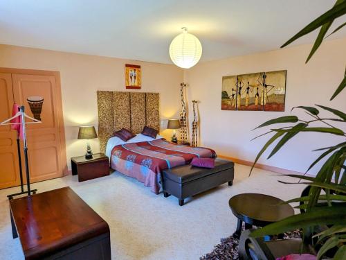 a bedroom with a bed and a desk and a table at Gîte Mécrin, 6 pièces, 10 personnes - FR-1-585-12 